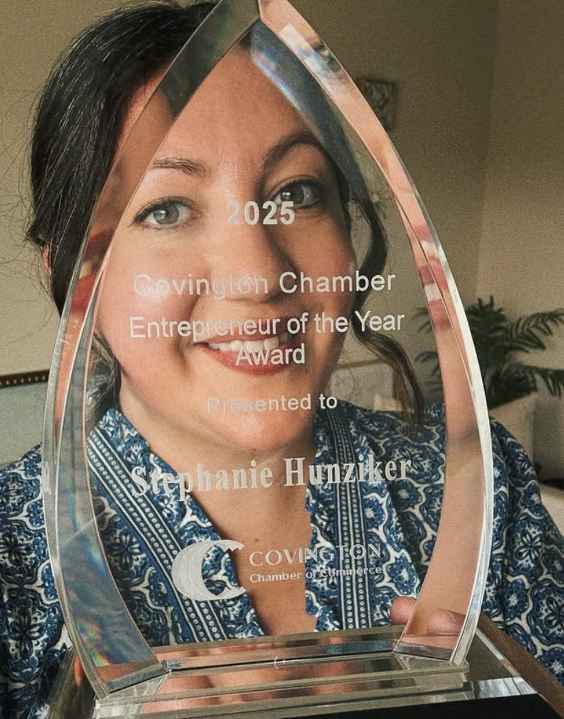 Stephanie Hunziker holding Covington Business Award